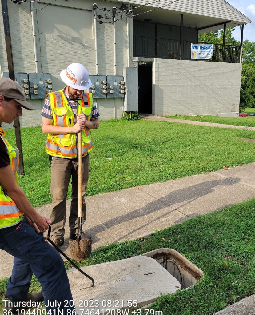 Fiber optic technicians opening vault.